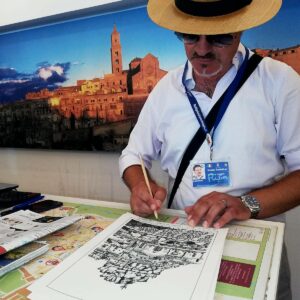 Antonio Pizzulli firma la sua opera ““La Rupe dell’Idris” 2019" e scrive una dedica affettuosa ai visitatori dei Sassi di Matera.